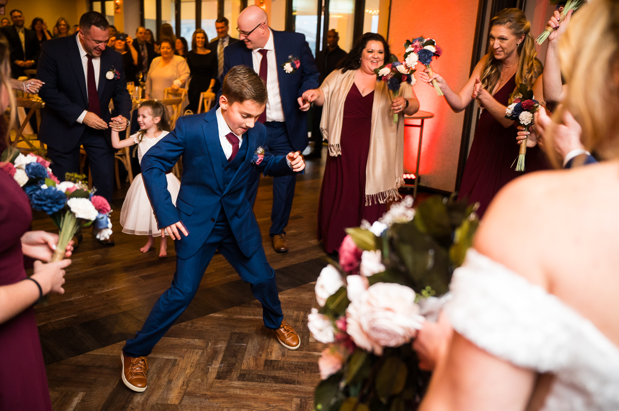best nj wedding reception photographer, rhinehart photographer, captures this vibrant, colorful fun image of guests and children as they dance together during this fun wedding reception at the reeds in stone harbor New Jersey 