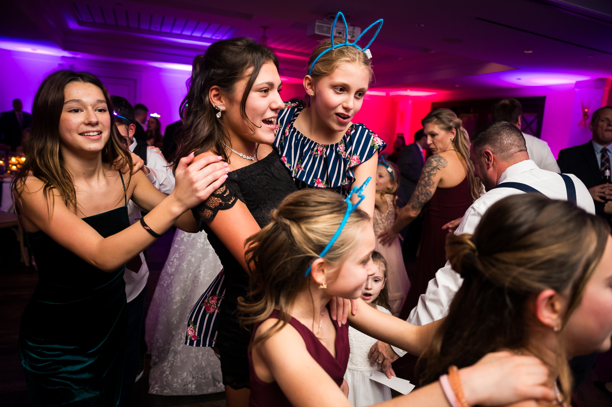Winter Reeds Stone Harbor Wedding reception photographer, rhinehart photography, captures this fun, vibrant colorful image of kids at they dance together during this family friendly wedding reception at the reeds in New Jersey 