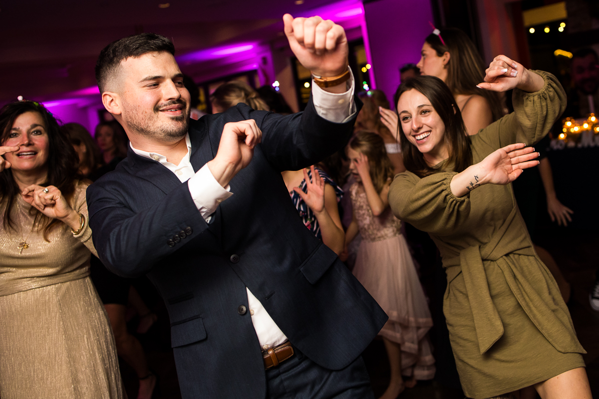 vibrant fun image of guests as they dance together at this fun wedding reception in New Jersey 