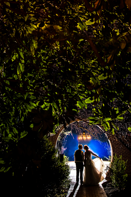 Stone Mill Inn Wedding photographer, Lisa Rhinehart, captures this creative end of the night shot of the couple at the moon gate as they end their wedding night together