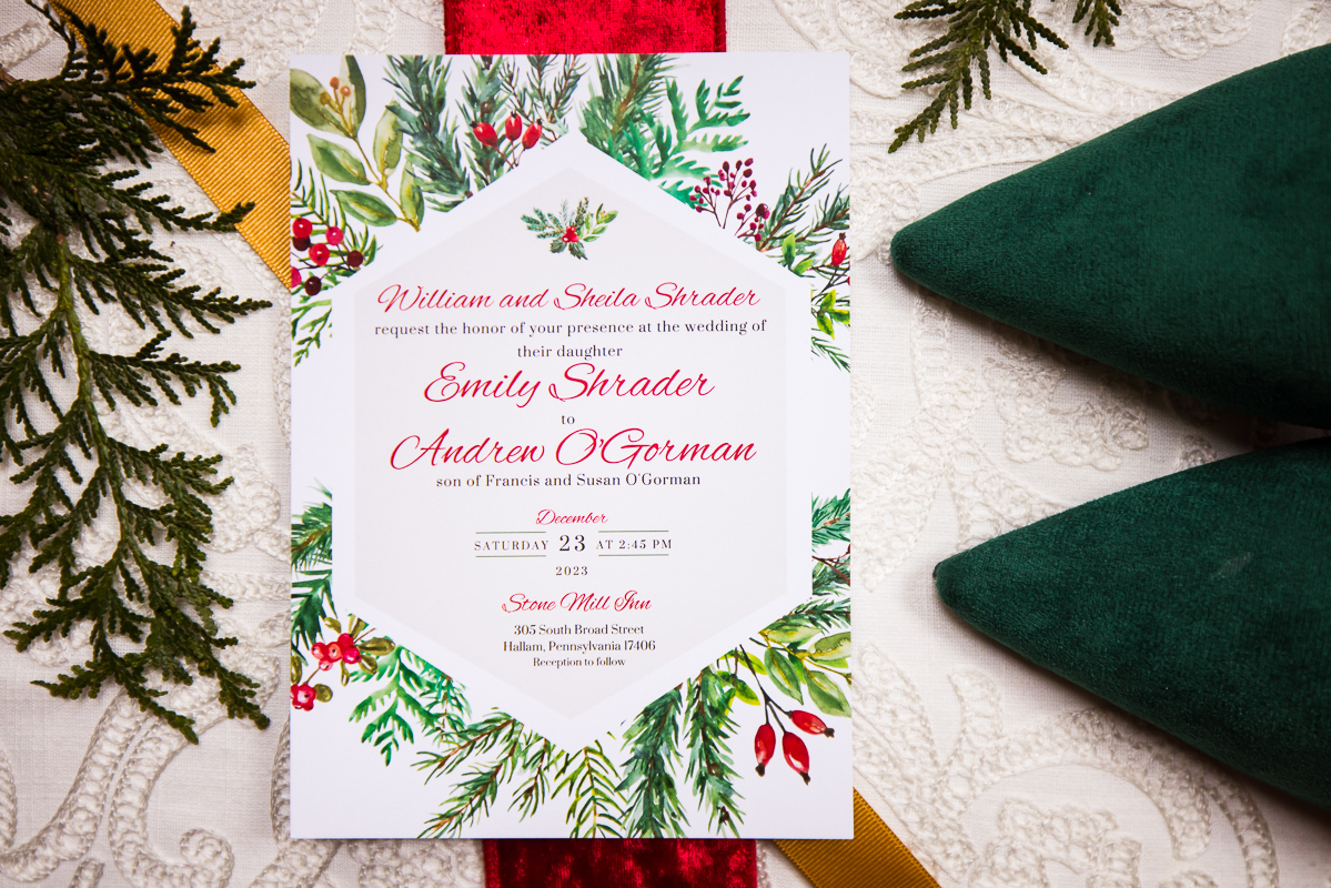 best pa wedding photographer, Lisa Rhinehart, captures this detail shot of the invitation, shoes, ribbon on a while table cloth for Christmas wedding decor Inso