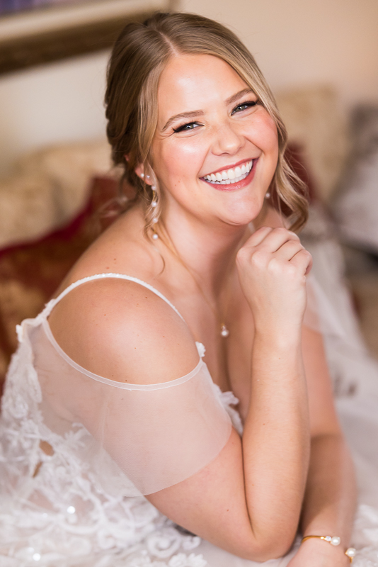 Stone Mill Inn Wedding photographer, Lisa Rhinehart, captures this stunning bridal portrait of the bride all smiles before her outdoor Christmas wedding ceremony in Hallam pa 