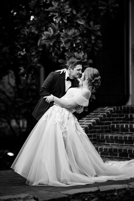 black and white image of the bride and groom as they lean into one another during their romantic portraits before their outdoor winter wedding in Hallam pa 