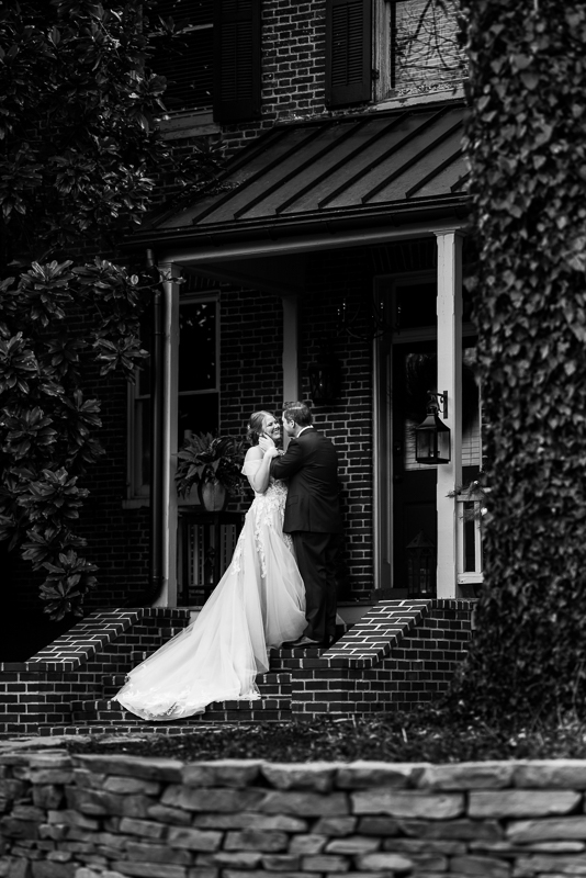 best pa wedding photographer, Lisa Rhinehart, captures this black and white image of the bride and groom as they see one another for the first time during their first look on the steps before their outdoor winter wedding 