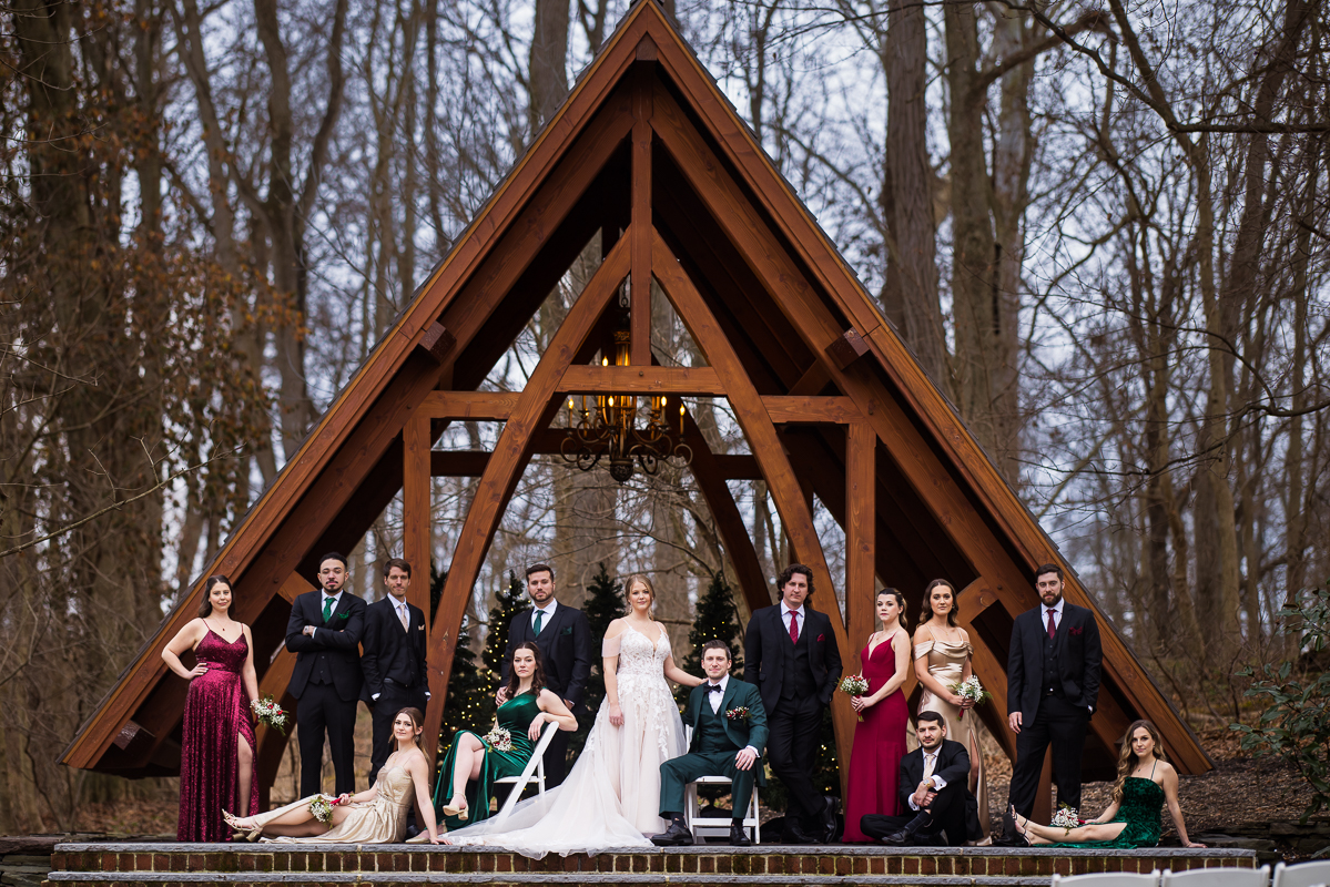 Stone Mill Inn Wedding photographer, Lisa Rhinehart, captures this outdoor vogue vanity fair shot of the wedding party in front of the abbey before their outdoor Christmas wedding