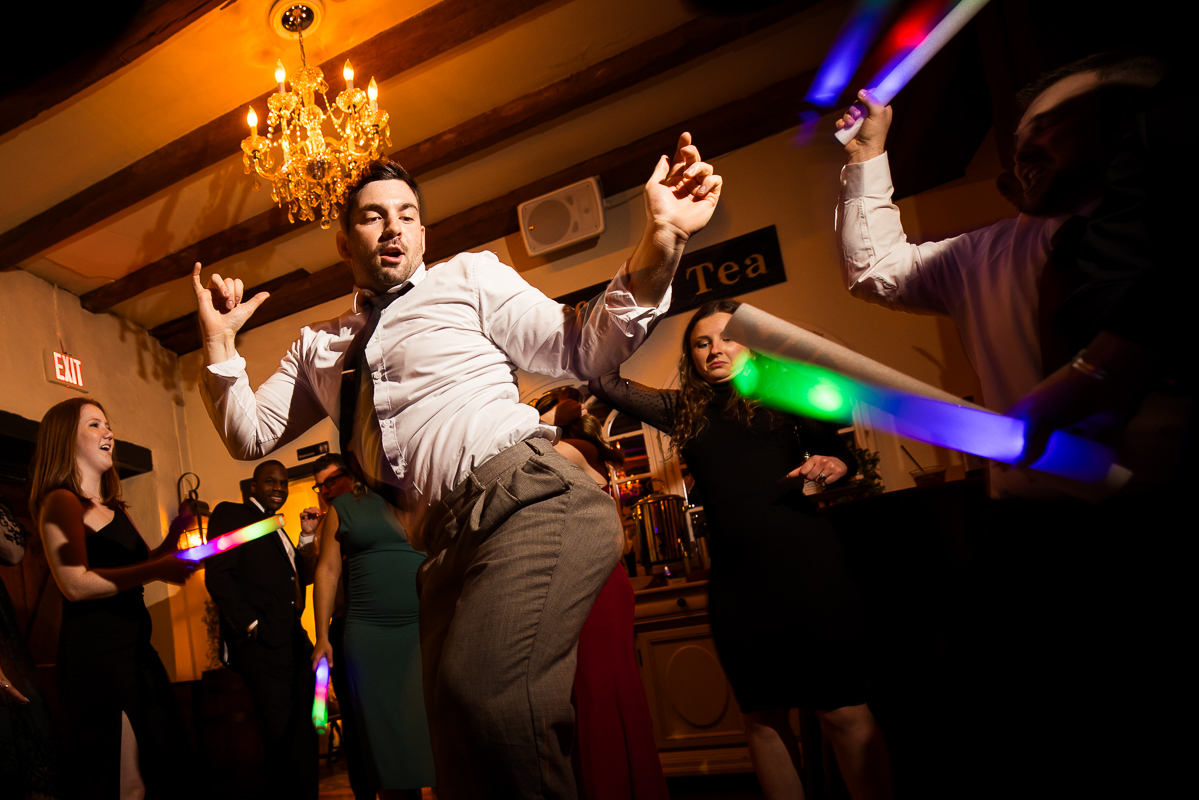 fun pa wedding reception photographer, Lisa Rhinehart, captures this candid image of guests as they dance and have a great time at this fun winter wedding reception in Hallam pa 