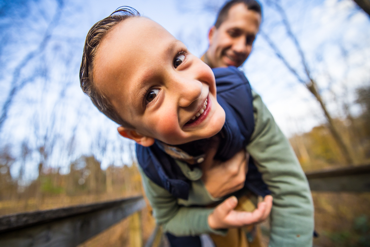 Lehigh Valley family photographer, Rhinehart Photography, captures this fun, candid, authentic moment of the dad playing with his son in nature at the wildlands conservancy in Emmaus pa 