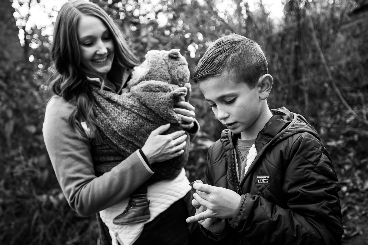 lifestyle family photographer, Lisa Rhinehart, captures this black and white image of the mom and her sons as they explore the outdoors at the wildlands conservancy in emmaus pa 