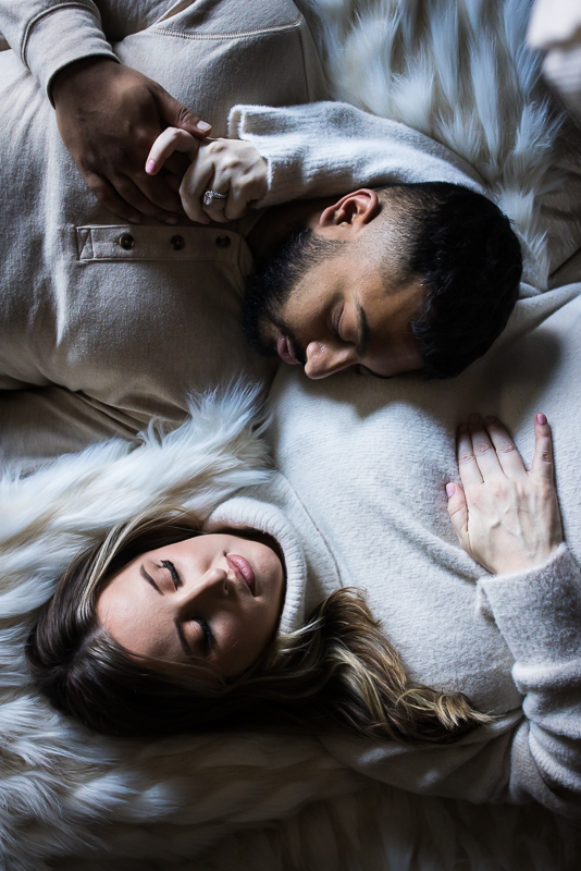 best pa family photographer, Lisa Rhinehart, captures this unique perspective of the husband and wife as they are cuddled up together in their neutral color palette attire during this cozy maternity session in central pa at the ashcombe mansion 