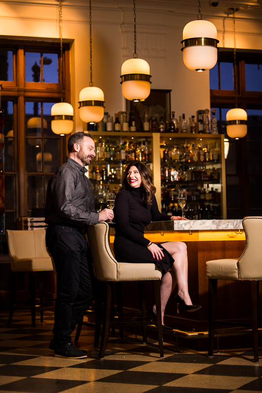 Yorktowne Hotel Wedding engagement photographer, Lisa Rhinehart, captures this fun, indoor image of the couple as they hang out together at the bar inside of the Yorktowne hotel in pa 