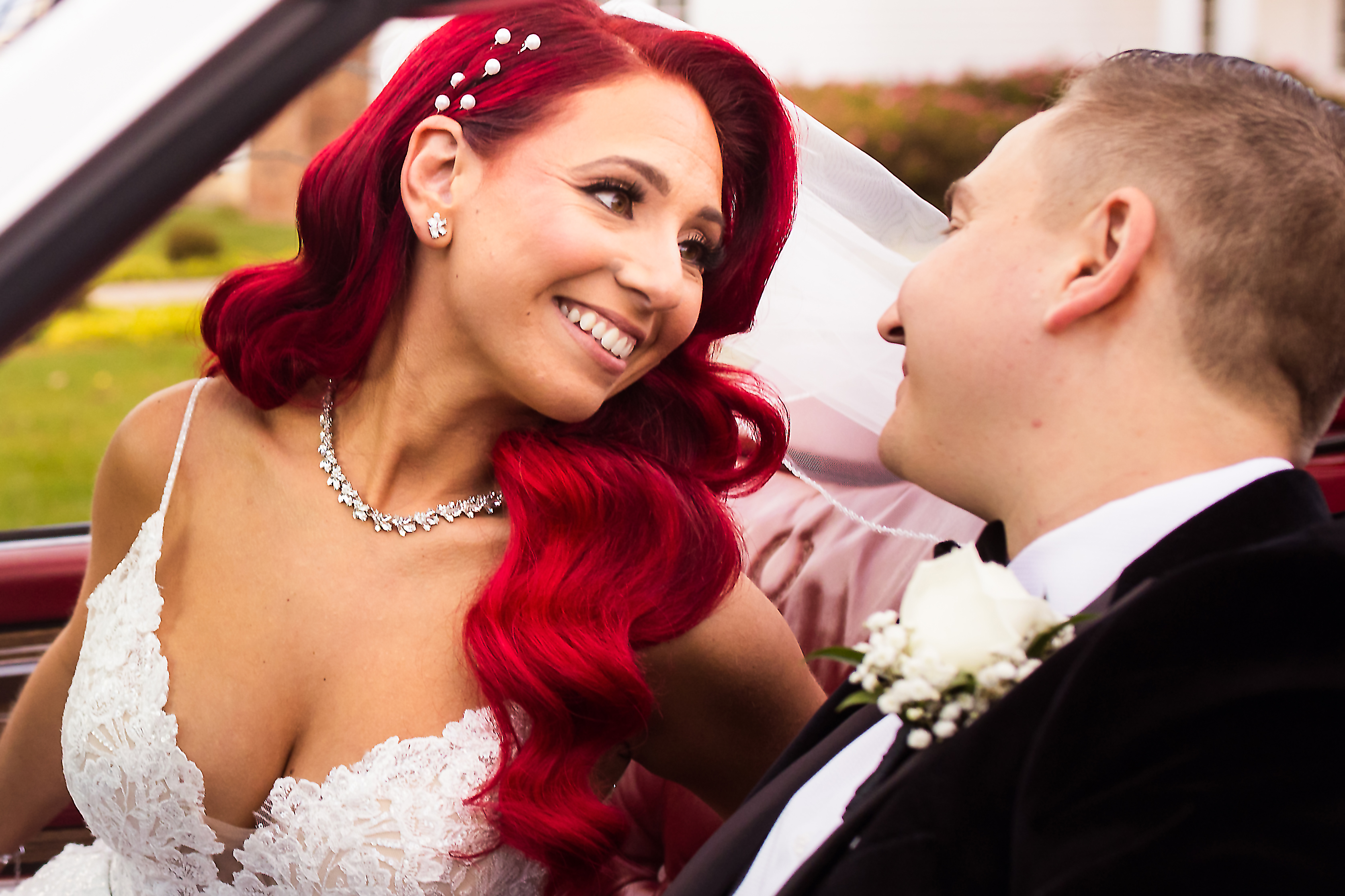 bride with red hair in convertible at their ryland inn wedding in morristown nj as photographed by creative award-winning photographer lisa rhinehart